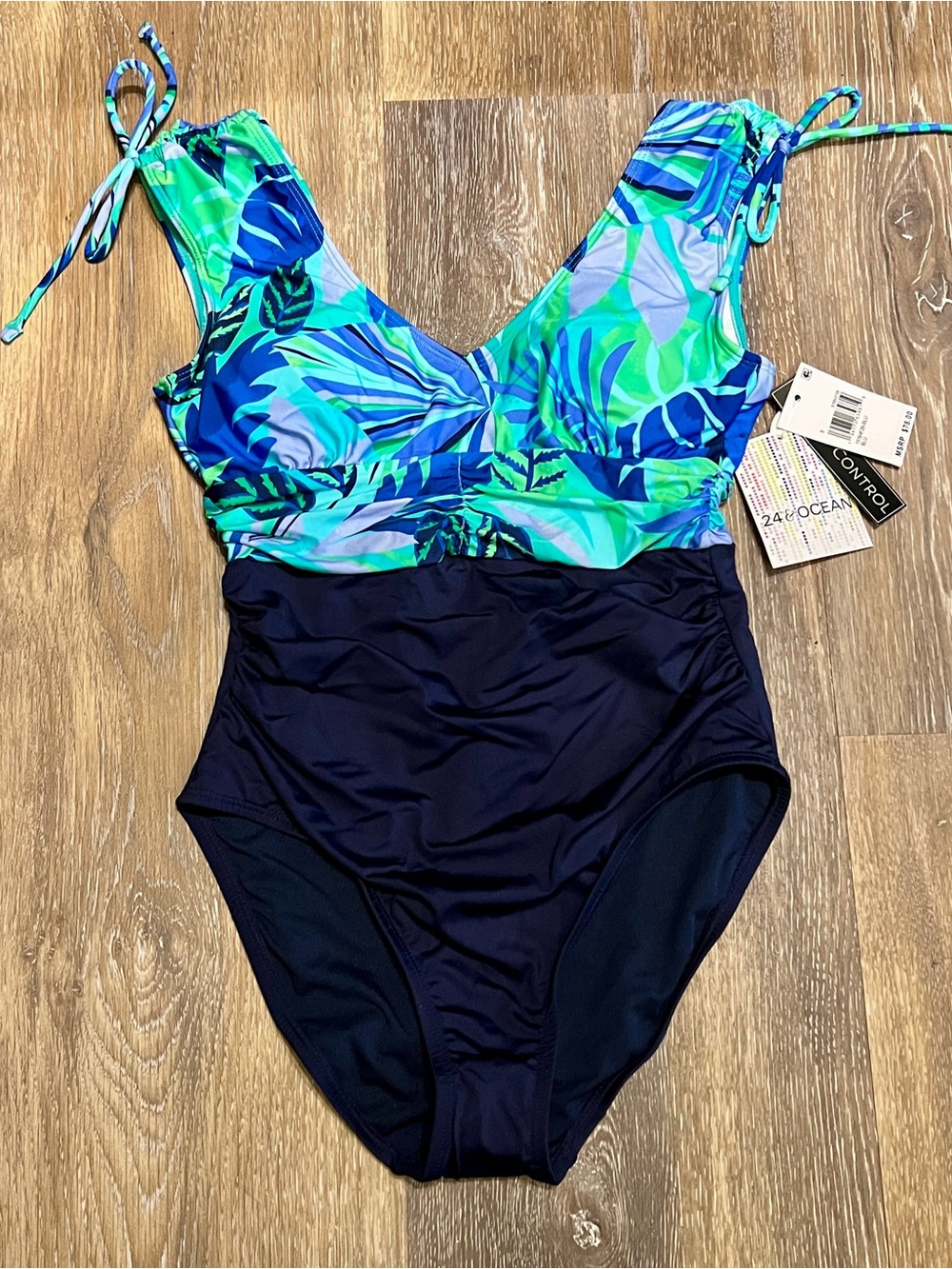 Woman’s 24 & Ocean Navy One-Piece Swimsuit with Green and Blue Tropical Print.